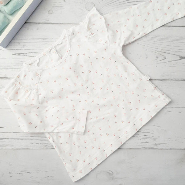 Polera algodón blanca con florcitas rosadas 6 meses Marca Tribu Estado Casi tiki